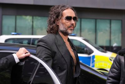 Russell Brand arrives at court to enter pleas on rape and sexual assault charges