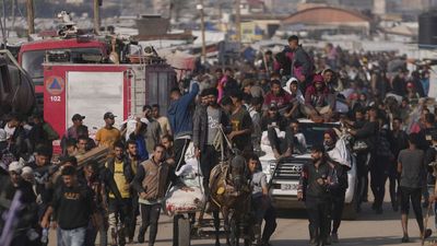 Dozens killed and scores injured in shooting near aid point in Gaza