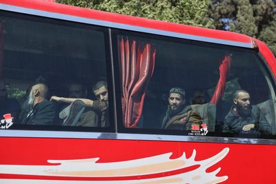 Syrian government and Kurdish-led force exchange prisoners in a step toward easing tensions