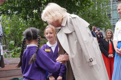 Queen ‘warms up’ six-year-old girl’s ‘cold hands’ during blustery outdoor event