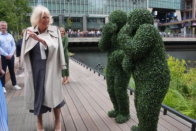 Bizarre moment Queen Camilla meets people dressed as bushes