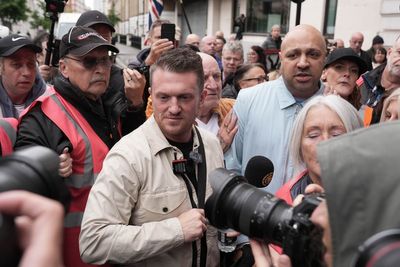 Tommy Robinson appears in court charged with harassing journalists