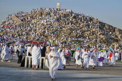 Muslim pilgrims seek forgiveness and shade on Mount Arafat during key Hajj ritual
