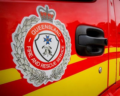 Queensland fire crews work to rescue man in his 80s stuck up to his neck in silo of fertiliser