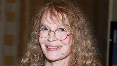 Mia Farrow's mantelpiece styling is personal but replicable – natural wood, antique pans, and family photos create an ultra-welcoming living room