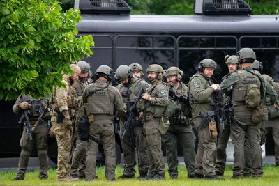 US politician and husband shot dead in 'politically motivated assassination' by suspect dressed as police officer