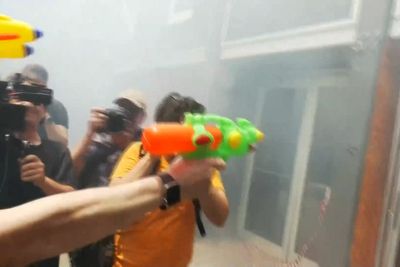Anti-tourism protesters confront hotel staff with flares and water pistols in Barcelona