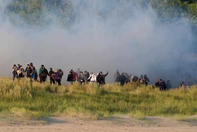 French police fire tear gas at migrants in Calais