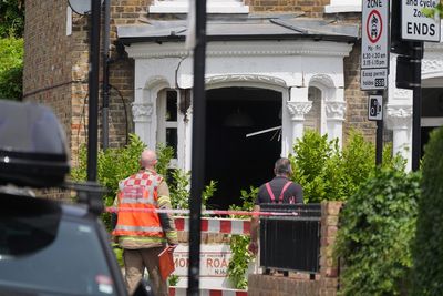 Charity worker found stabbed in house after gas explosion