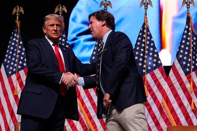 Newsmax once courted Tucker Carlson. Now they say he’s irrelevant after Trump-Iran criticism.