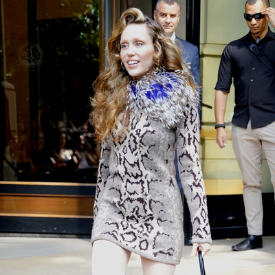 Miley Cyrus Slides Into a Feathered Snakeskin Mini Dress and a $4,100 Valentino Bag