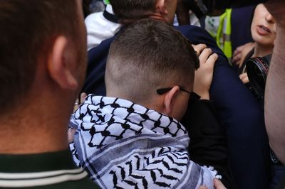 Kneecap greeted by hundreds at court as rap group member faces terrorism charge