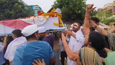 Air India crash survivor carries coffin of brother killed in disaster