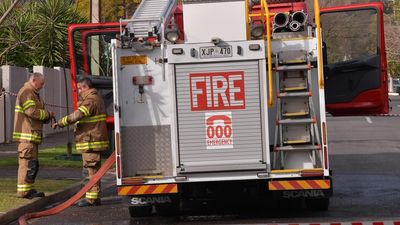 Woman on murder charge after body found in house fire