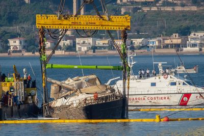 Superyacht is pulled from the seabed 10 months after sinking off Sicily