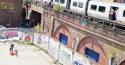 Moment delivery driver throws water bottles to passengers trapped on sweltering London train