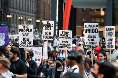 Police have charged a woman they claim drove through crowd of anti-ICE protesters