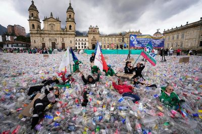 Colombian waste pickers inundate iconic Bogota square with plastic bottles to protest falling wages