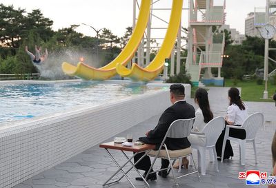 Kim Jong Un watches swimmers use waterslide as North Korea opens huge beach resort to boost tourism
