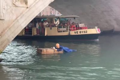 Life-size mannequin of Jeff Bezos lying on a giant Amazon box dropped into Venice canal in wedding protest
