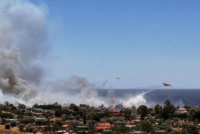 Evacuations south of Athens as wildfires spread in extreme heat
