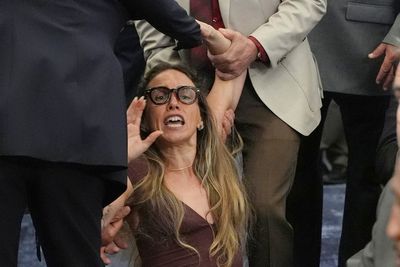 Shocking scenes as woman dragged out of meeting for trying to speak during hearing on ICE rules