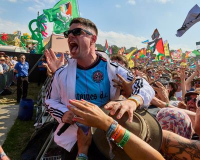 Kneecap at Glastonbury review – sunkissed good vibes are banished by rap trio’s feral, furious flows