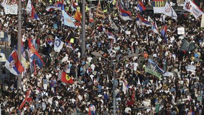 Riot police clash with student-led protesters calling for snap elections in Serbia