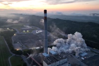 Moment 800-foot-tall power station chimney crumbles to ground in blast