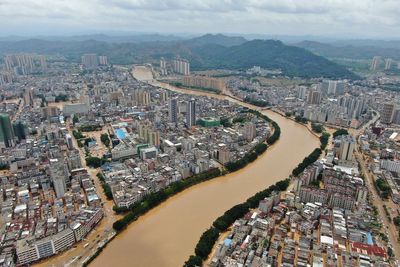 China on high alert for floods as record rain triggers landslides and building collapse
