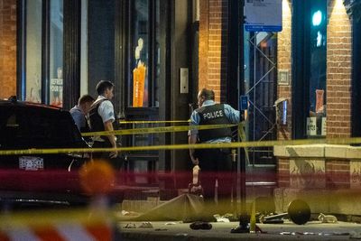 Four dead and 14 hurt after gunmen open fire on crowd outside a Chicago club in mass shooting: Suspects remain free