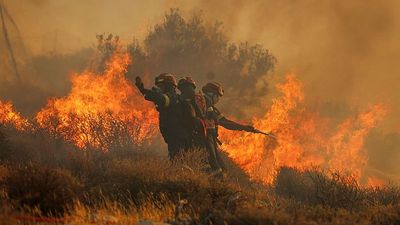 Greek firefighters race to contain wildfires that forced thousands to flee on Crete