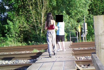 Children dancing and taking selfies on a railway line causes closure of pedestrian level crossing