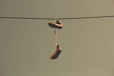 What It Means When You See Shoes Hanging from Power Lines