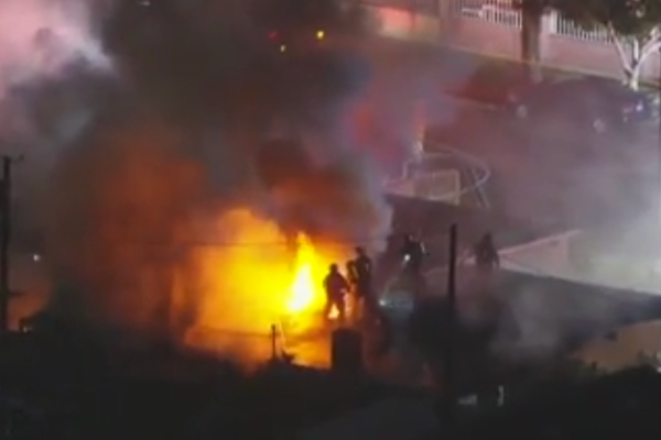 One dead and woman left in critical condition after fireworks explode and light a whole city block on fire