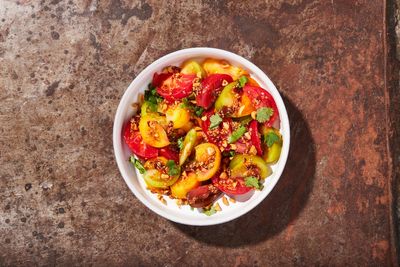 Savory-spicy peanut dressing complements the sweetness of this tomato salad
