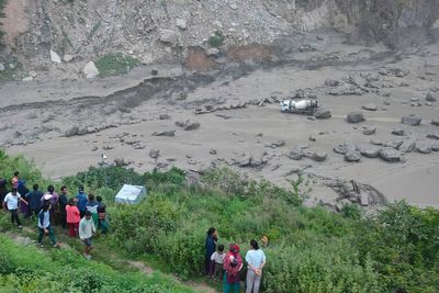 Floods sweep away 18 people and bridge linking Nepal to China