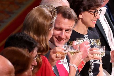 Winking Macron clinks glasses with royals at dazzling Windsor Castle state banquet