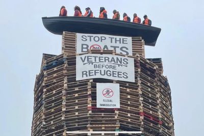 Calls for removal of migrant effigies in boat placed on loyalist bonfire in NI