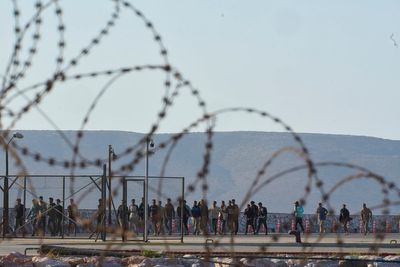 Photos show migrants intercepted near Crete arrive at the Greek port of Lavrio from Libya