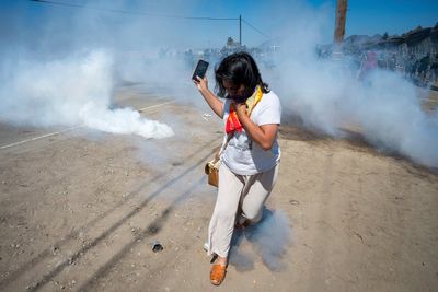 Photos of a confrontation between protesters and federal officials outside California farm