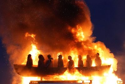 Life-size mannequins in migrant boat burn on Northern Ireland bonfire