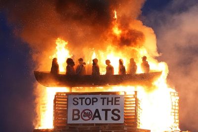 Effigy of migrant boat burns on top of Northern Ireland bonfire