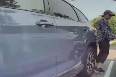 Moment woman attacks Tesla in school parking lot