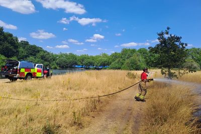 Firefighters tackle blaze in London park as brigade issues wildfire warning