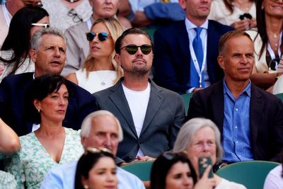 Leonardo DiCaprio laughs with Wimbledon spectators in Royal Box