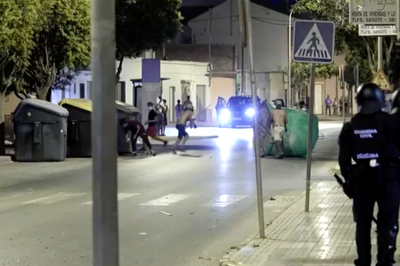 Anti-migrant groups throw bottles at riot police in Spain during unrest