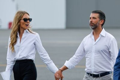 Donald Trump Jr. and Bettina Anderson pack on the PDA while waiting for the president