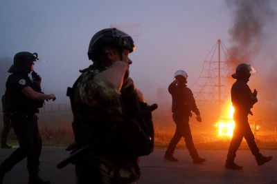 French riot police in early morning clash with migrants in coastal town