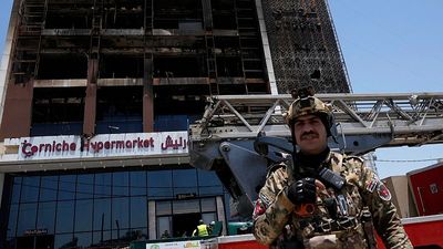 Officials in Iraq struggle to identify 18 bodies from shopping centre fire that reportedly killed 63